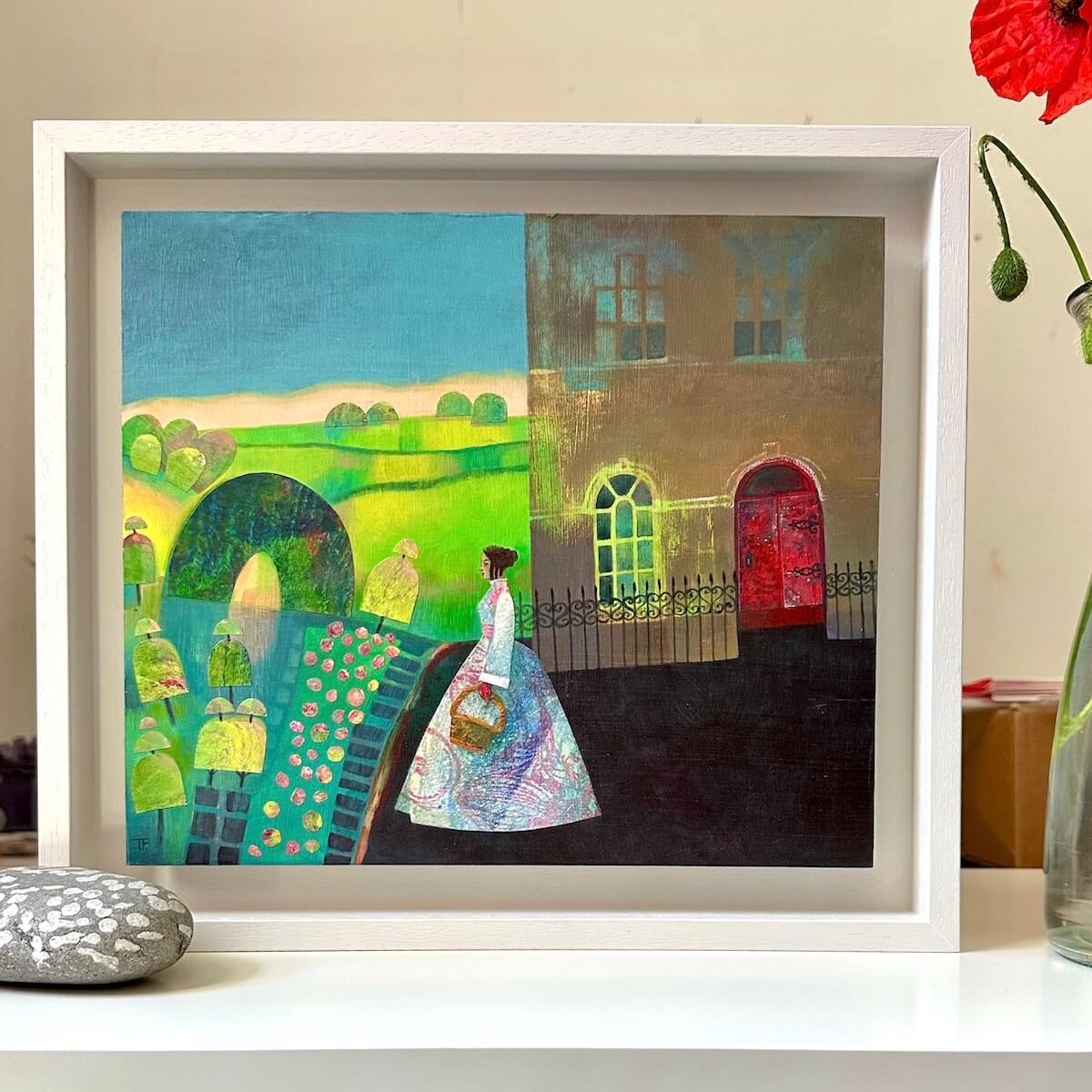 Teresa Flavin's The Topiary Garden painting in a white frame on a white table.