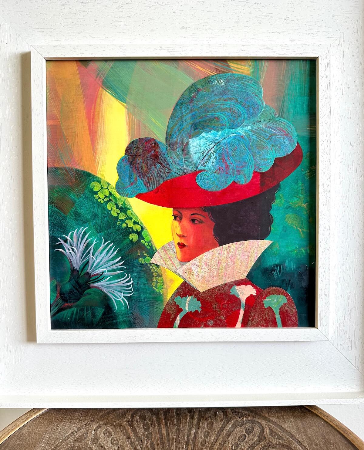 Angelique painting by Teresa Flavin shown in a white St Ives frame sat on a vintage wooden chair.