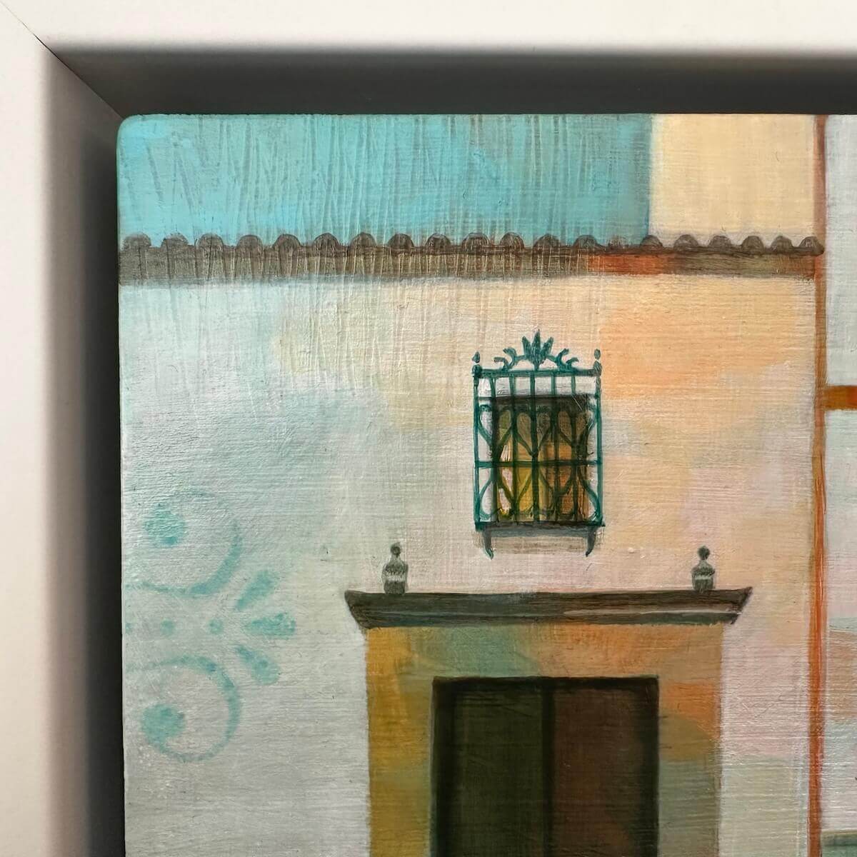 Framed detail of a building facade with a decorative window and architectural details.