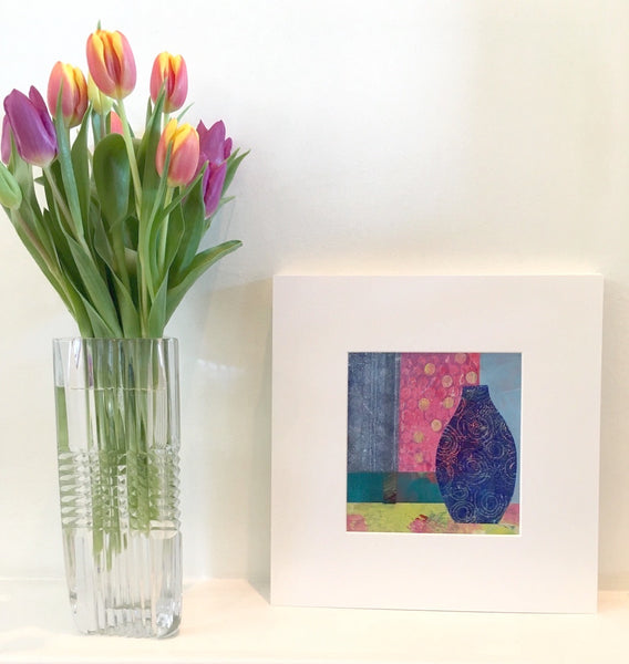 The Coming Light by Teresa Flavin Artist, abstract still life mixed media painting shown in white mount on shelf next to tulips in vase.